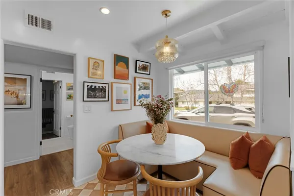 a view of a dining room with furniture window and wooden floor