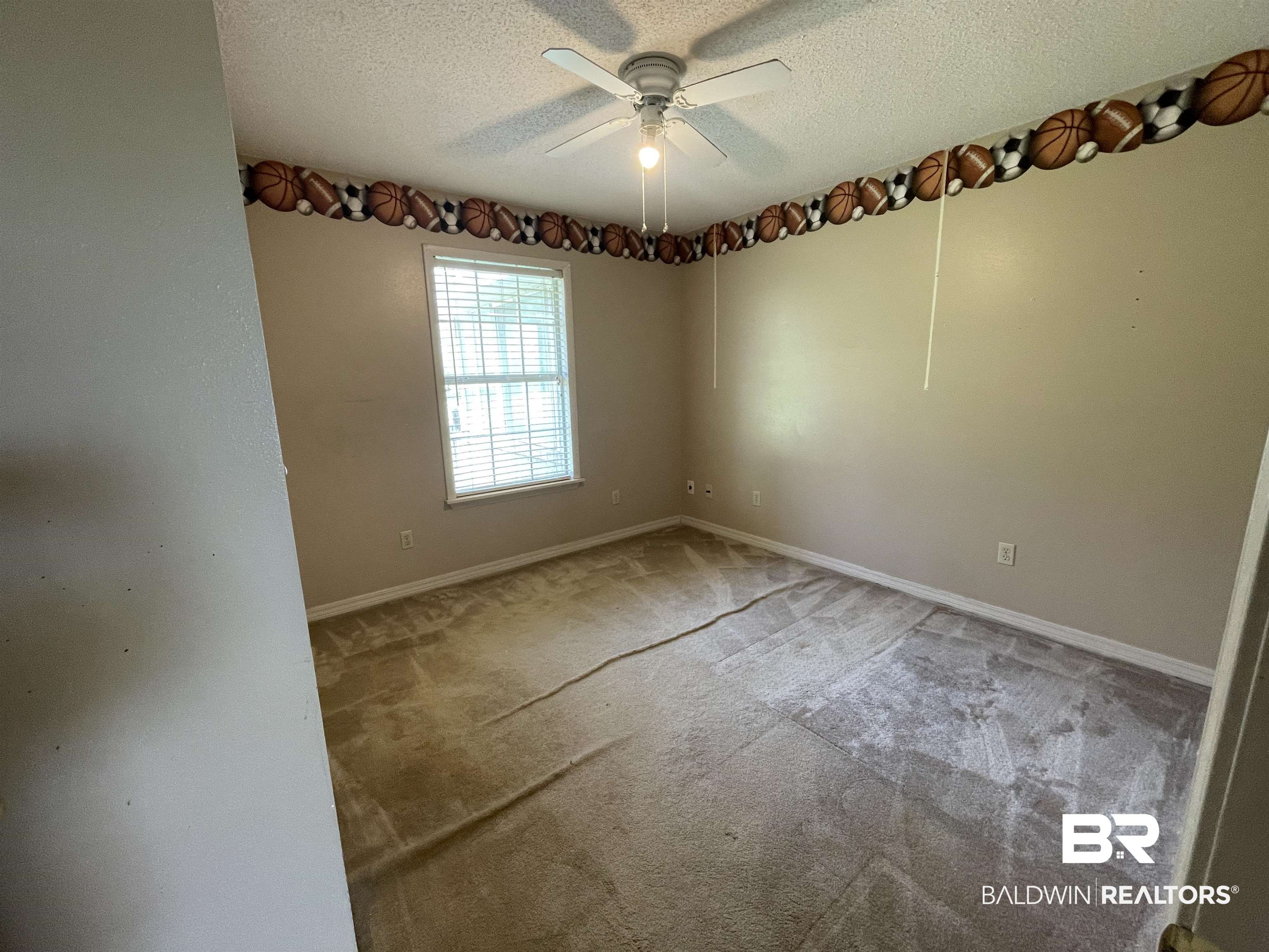 739 Smithfield Road Atmore, AL 36502 - Photo 9 of 18 Empty room featuring a textured ceiling, ceiling fan, baseboards, and carpet