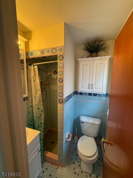 4032 Quakerbridge Road Lawrence Township, NJ 08648 - Photo 7 of 9 a bathroom with a granite countertop toilet a sink and a shower
