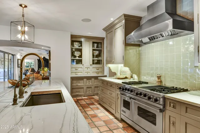 a kitchen with stainless steel appliances granite countertop a stove and a sink