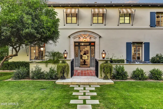a view of a house with garden and a swimming pool