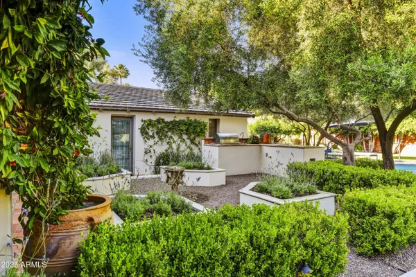 a view of a house with patio and garden