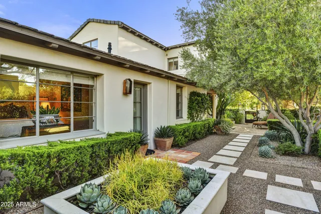 a front view of a house with garden