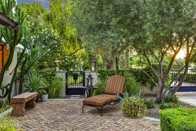 a view of a backyard with furniture and a garden