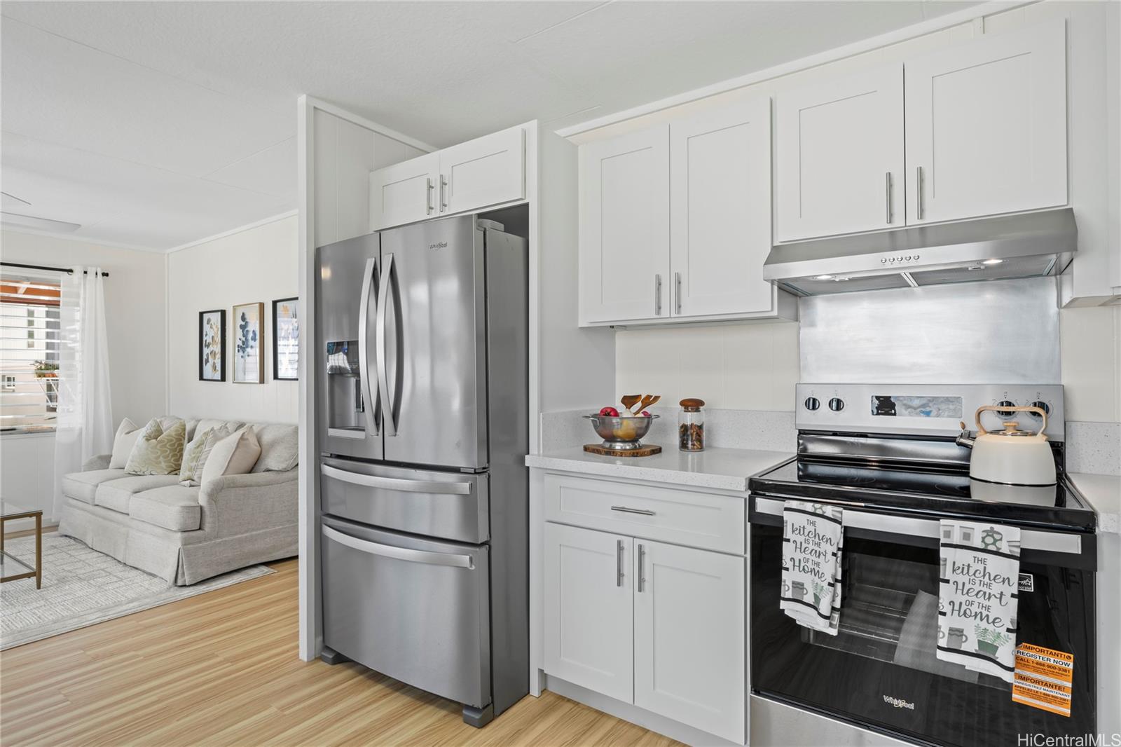 125 Milo Lane Honolulu, HI 96813 - Photo 2 of 16 a kitchen with a refrigerator stove and white cabinets