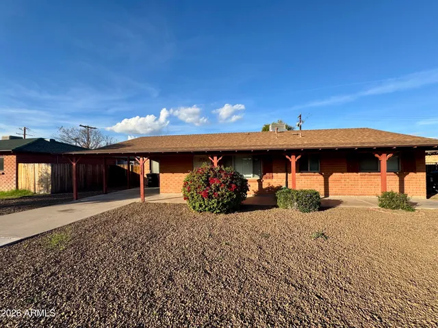 a view of a house with a yard and garage