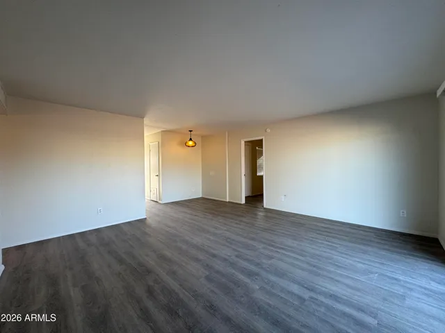 a view of an empty room and wooden floor