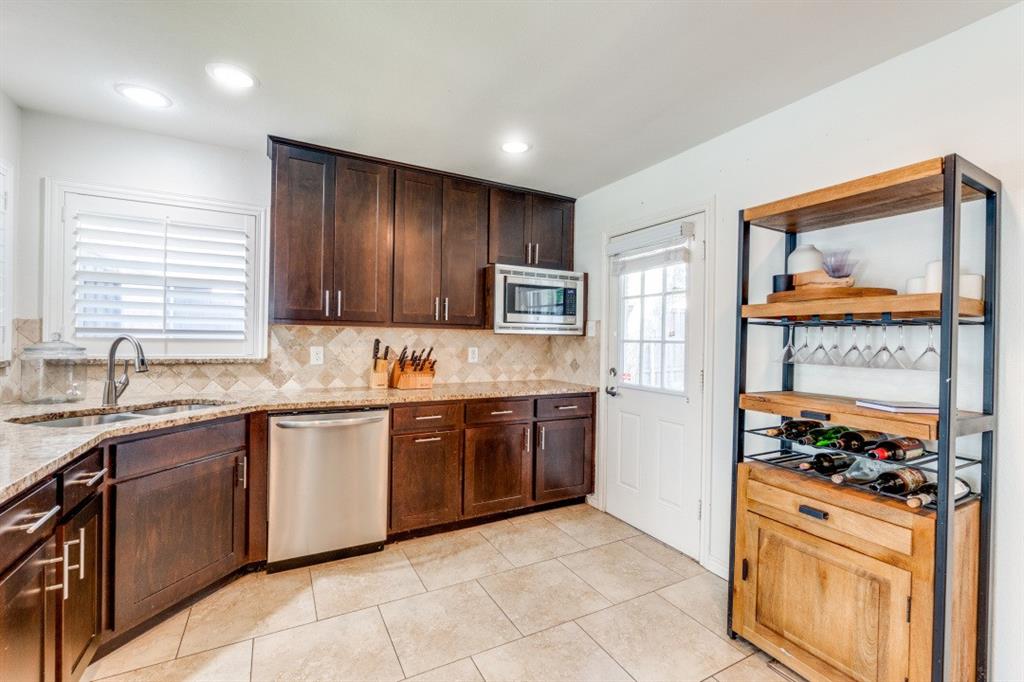 4303 Skillman Street Dallas, TX 75206 - Photo 13 of 25 a kitchen with stainless steel appliances granite countertop a stove sink and cabinets