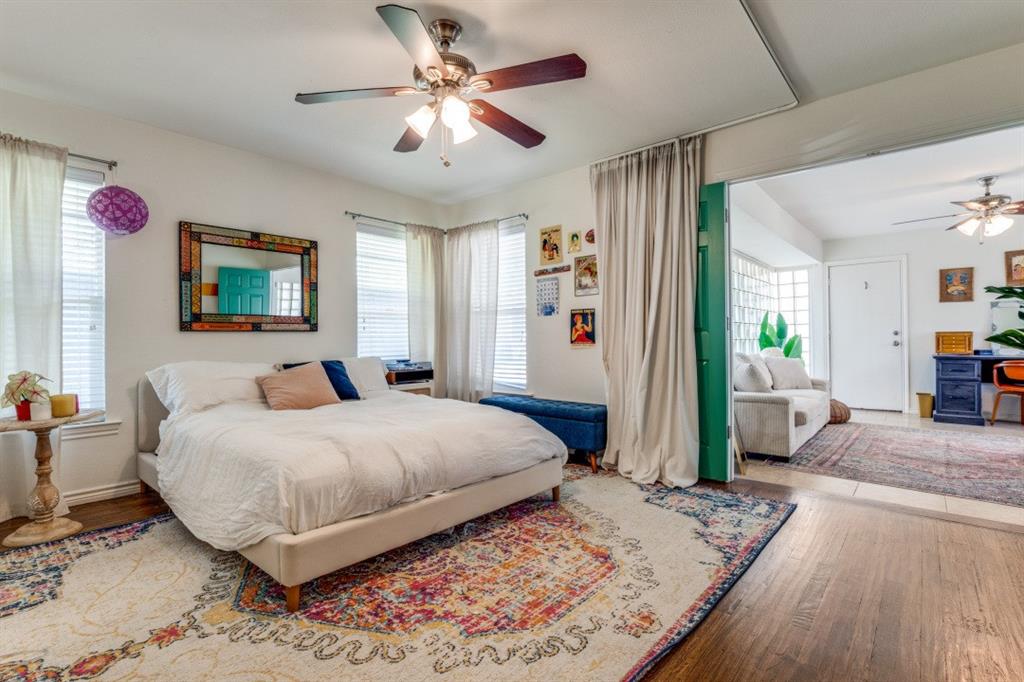 4303 Skillman Street Dallas, TX 75206 - Photo 15 of 25 a bedroom with a large bed a couch and dresser