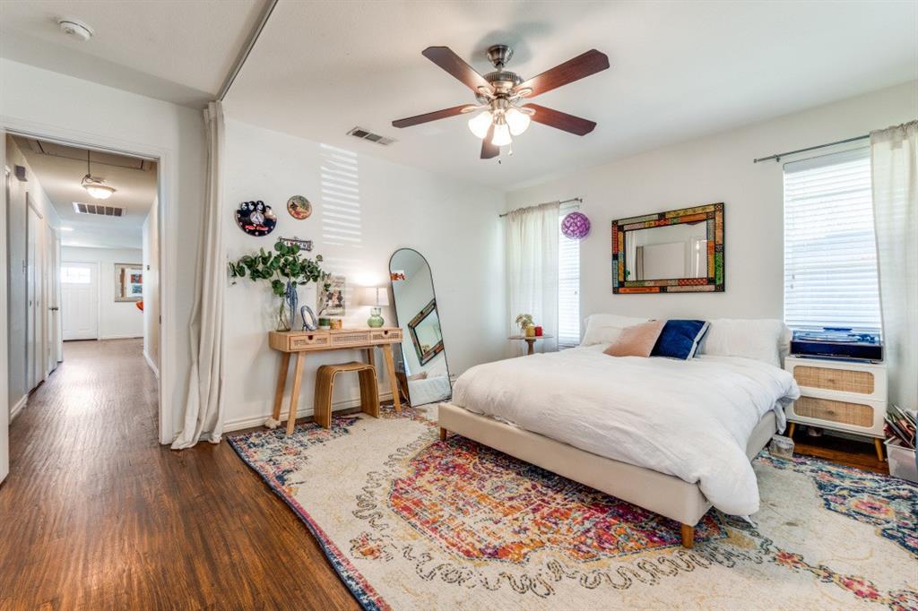 4303 Skillman Street Dallas, TX 75206 - Photo 16 of 25 a bedroom with a large bed and a wooden floor