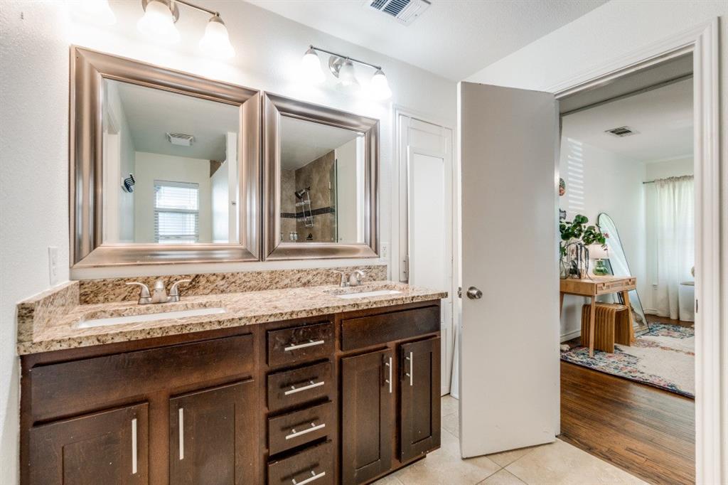 4303 Skillman Street Dallas, TX 75206 - Photo 17 of 25 a bathroom with a granite countertop sink and a mirror