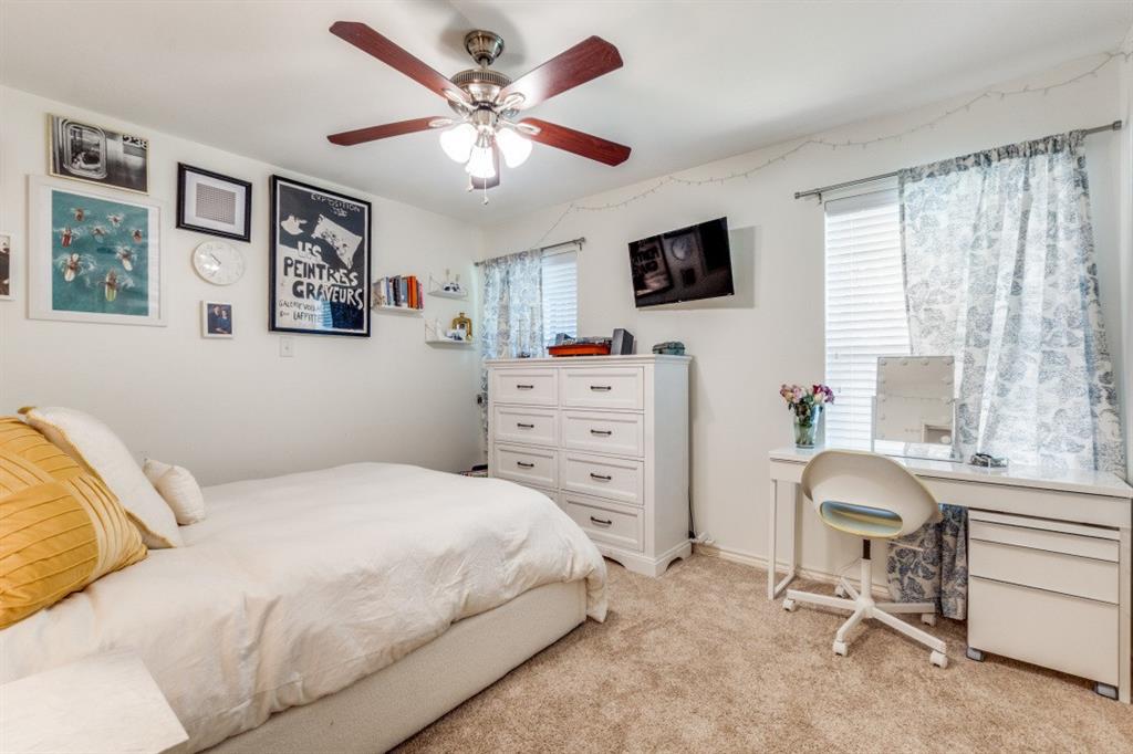 4303 Skillman Street Dallas, TX 75206 - Photo 18 of 25 a bedroom with a bed and a flat screen tv