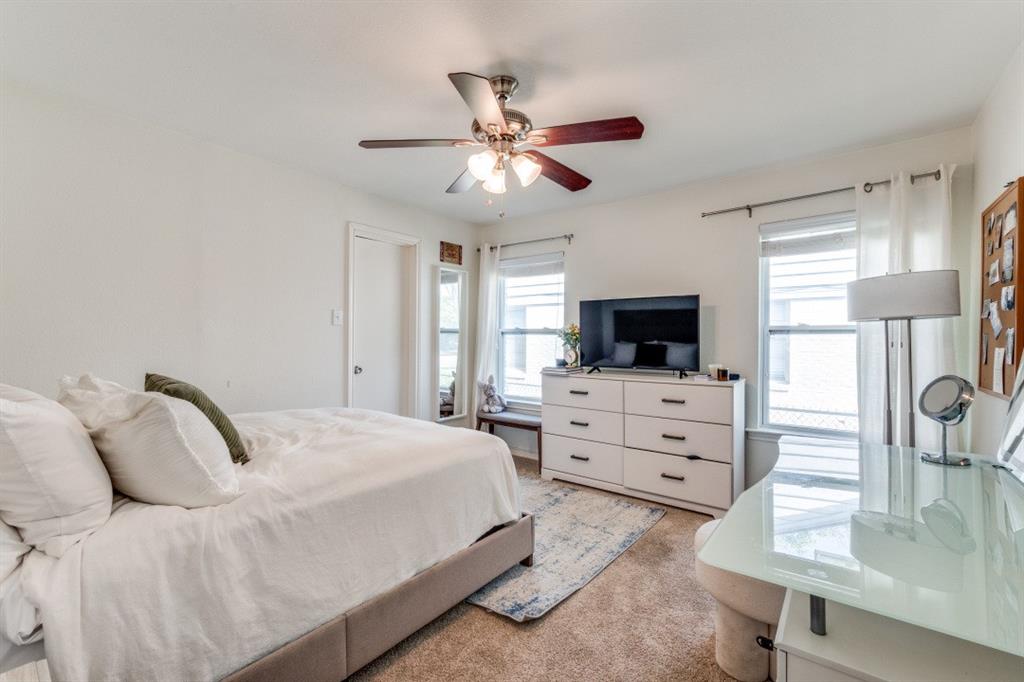 4303 Skillman Street Dallas, TX 75206 - Photo 19 of 25 a bedroom with a bed and a flat screen tv