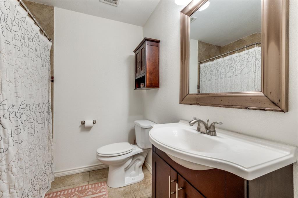 4303 Skillman Street Dallas, TX 75206 - Photo 21 of 25 a bathroom with a sink toilet and a mirror