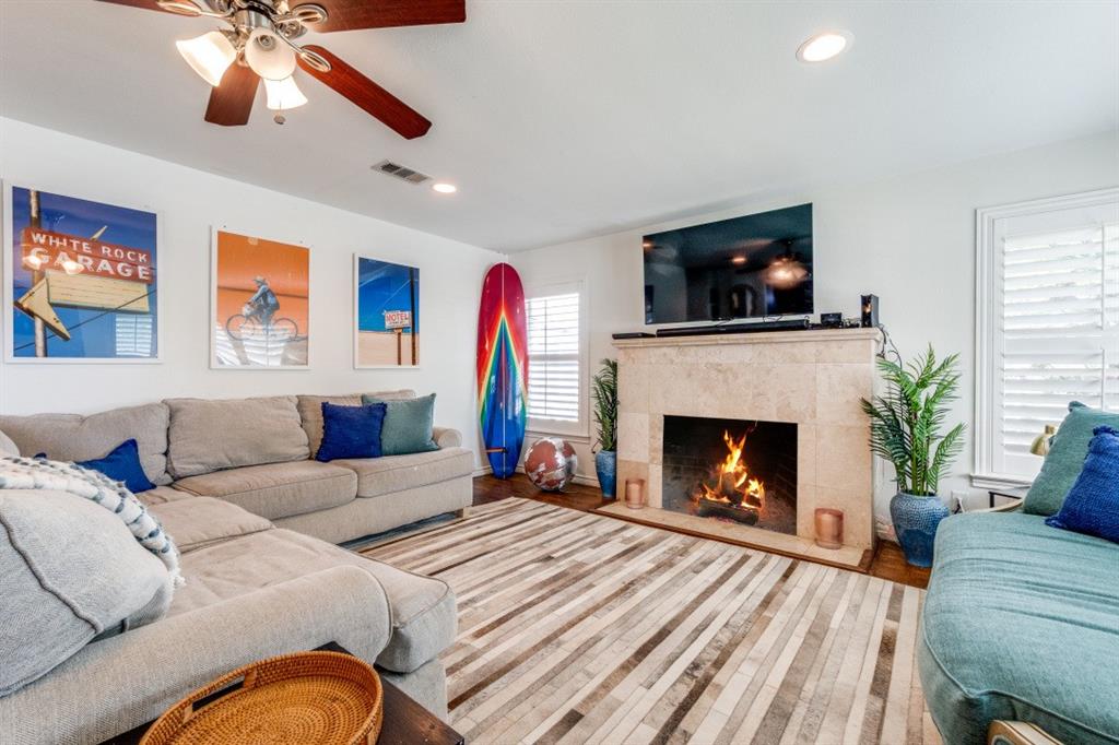 4303 Skillman Street Dallas, TX 75206 - Photo 5 of 25 a living room with furniture a fireplace and a flat screen tv