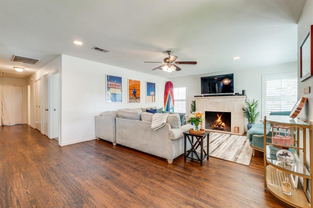 4303 Skillman Street Dallas, TX 75206 - Photo 8 of 25 a living room with furniture a fireplace and a flat screen tv
