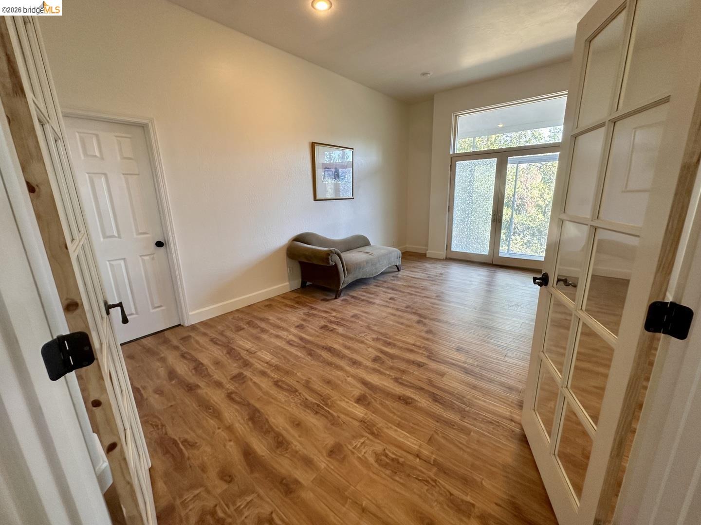 2080 Nelson Road Camino, CA 95709 - Photo 24 of 55 Wood-finish flooring, white walls, and French doors with privacy glass