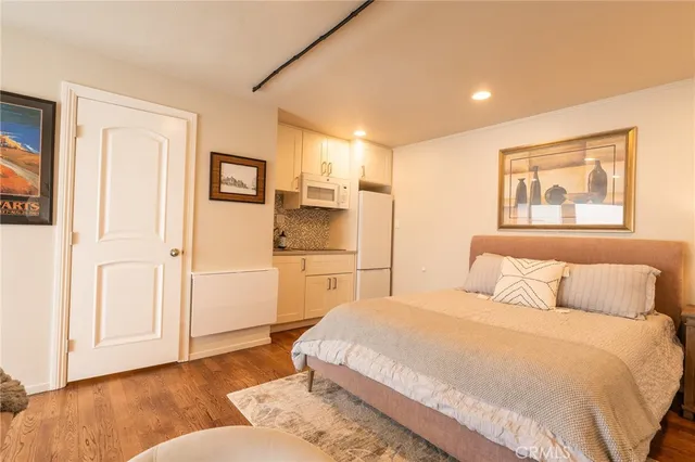 a spacious bedroom with a bed and a couch