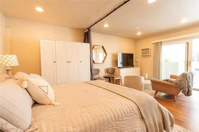 a bedroom with a bed and a flat screen tv