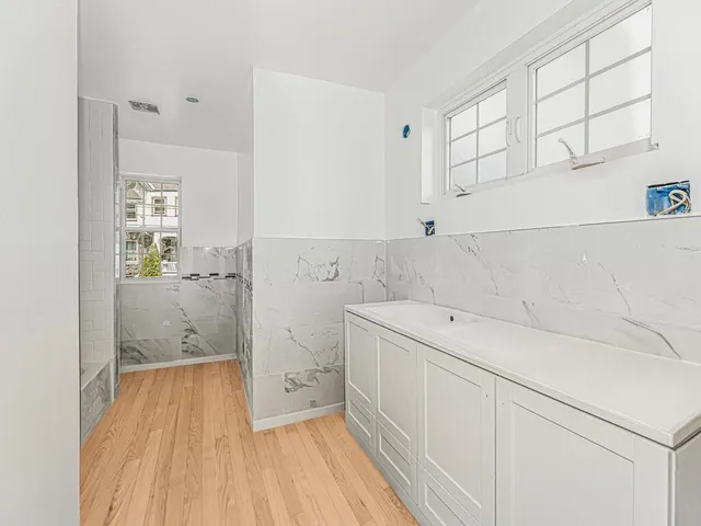 a view of a bathroom with sink and wooden floor