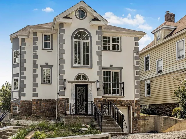 a front view of a house with large windows