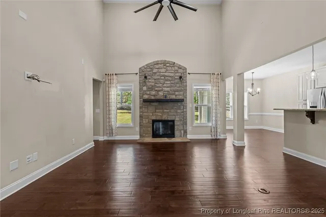 a view of a livingroom with wooden floor a fireplace and window
