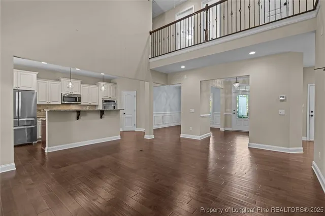 a view of kitchen with refrigerator and window