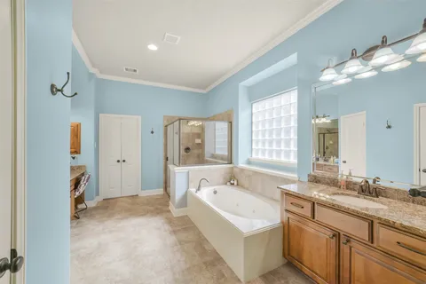 a spacious bathroom with a granite countertop tub sink and mirror