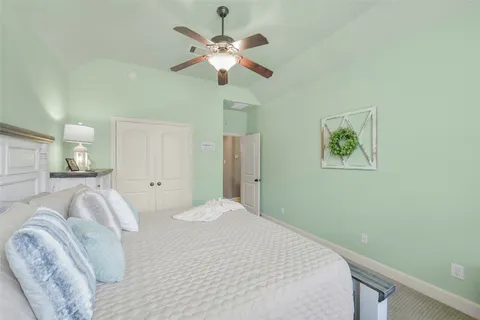 a bedroom with a large bed and a chandelier