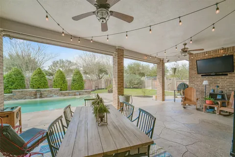 a view of a dining room with furniture water view and a floor to ceiling window