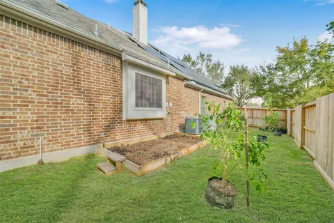 a view of backyard with a garden and deck