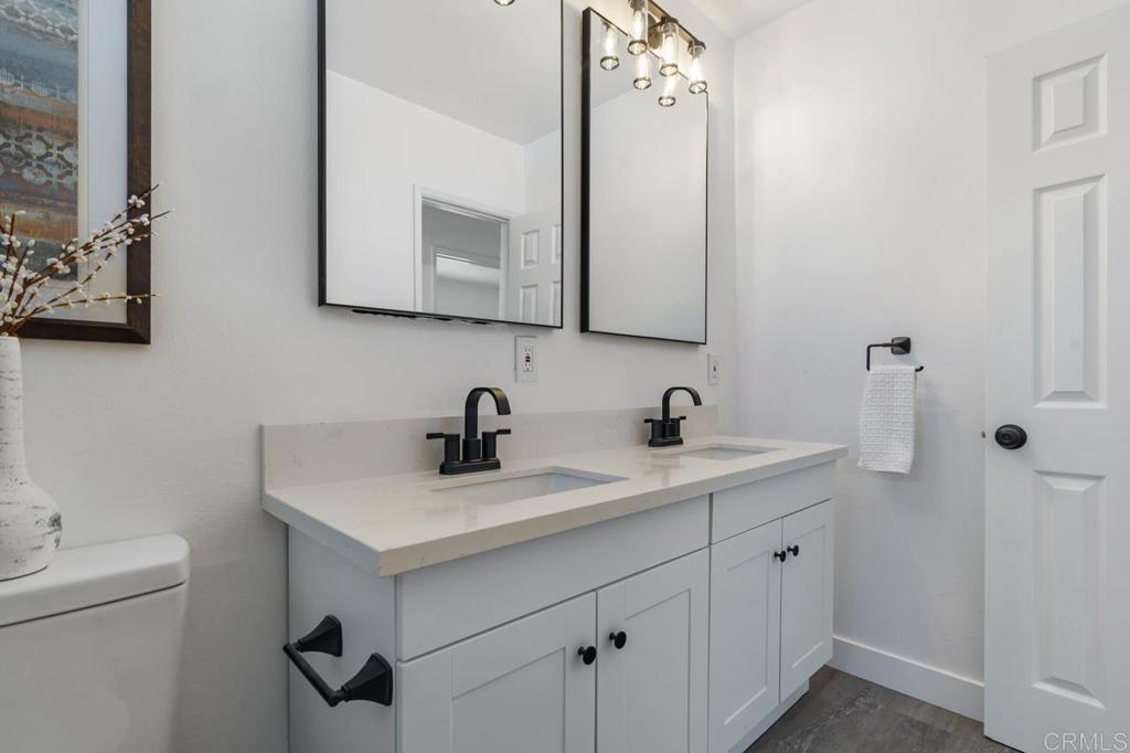 935 Swallow Drive Vista, CA 92083 - Photo 30 of 43 a bathroom with a sink vanity and mirror
