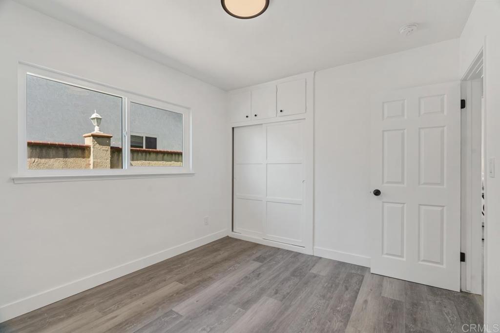 935 Swallow Drive Vista, CA 92083 - Photo 32 of 43 a view of a room with wooden floor and white walls