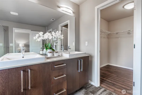 a bathroom with a double vanity sink and a mirror
