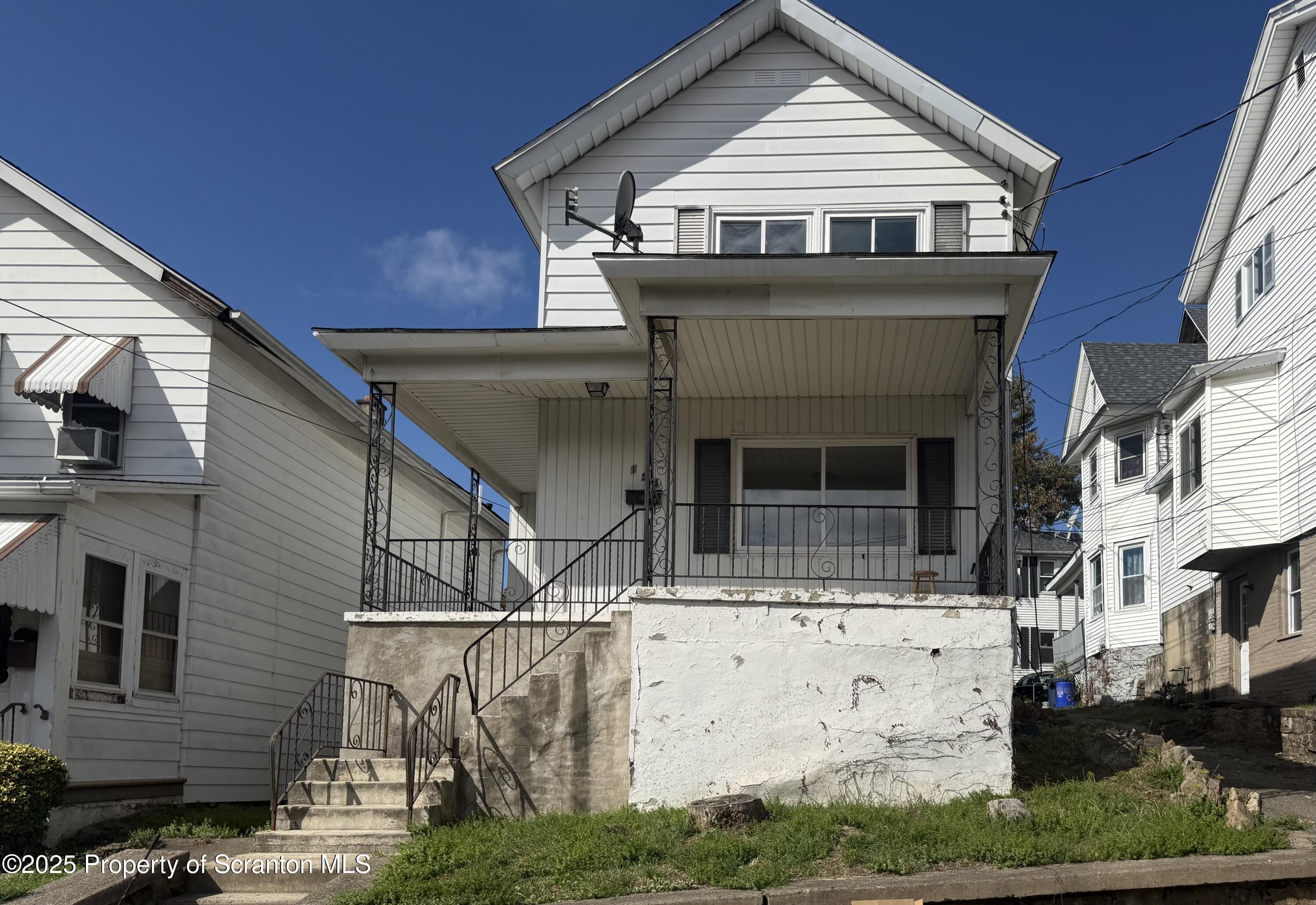 a view of a white house with large windows