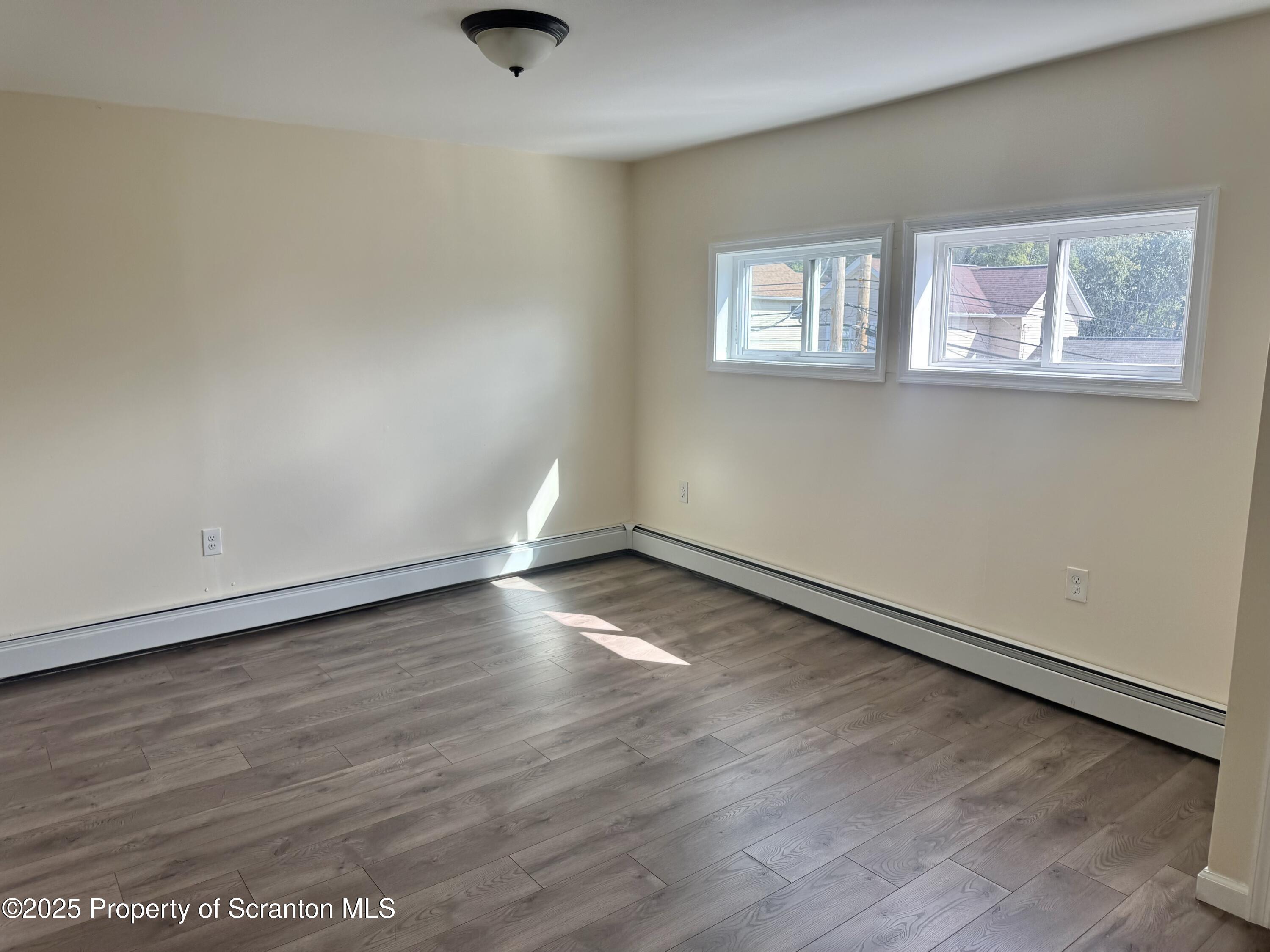 154 South Sumner Avenue Scranton, PA 18504 - Photo 11 of 15 an empty room with wooden floor and windows