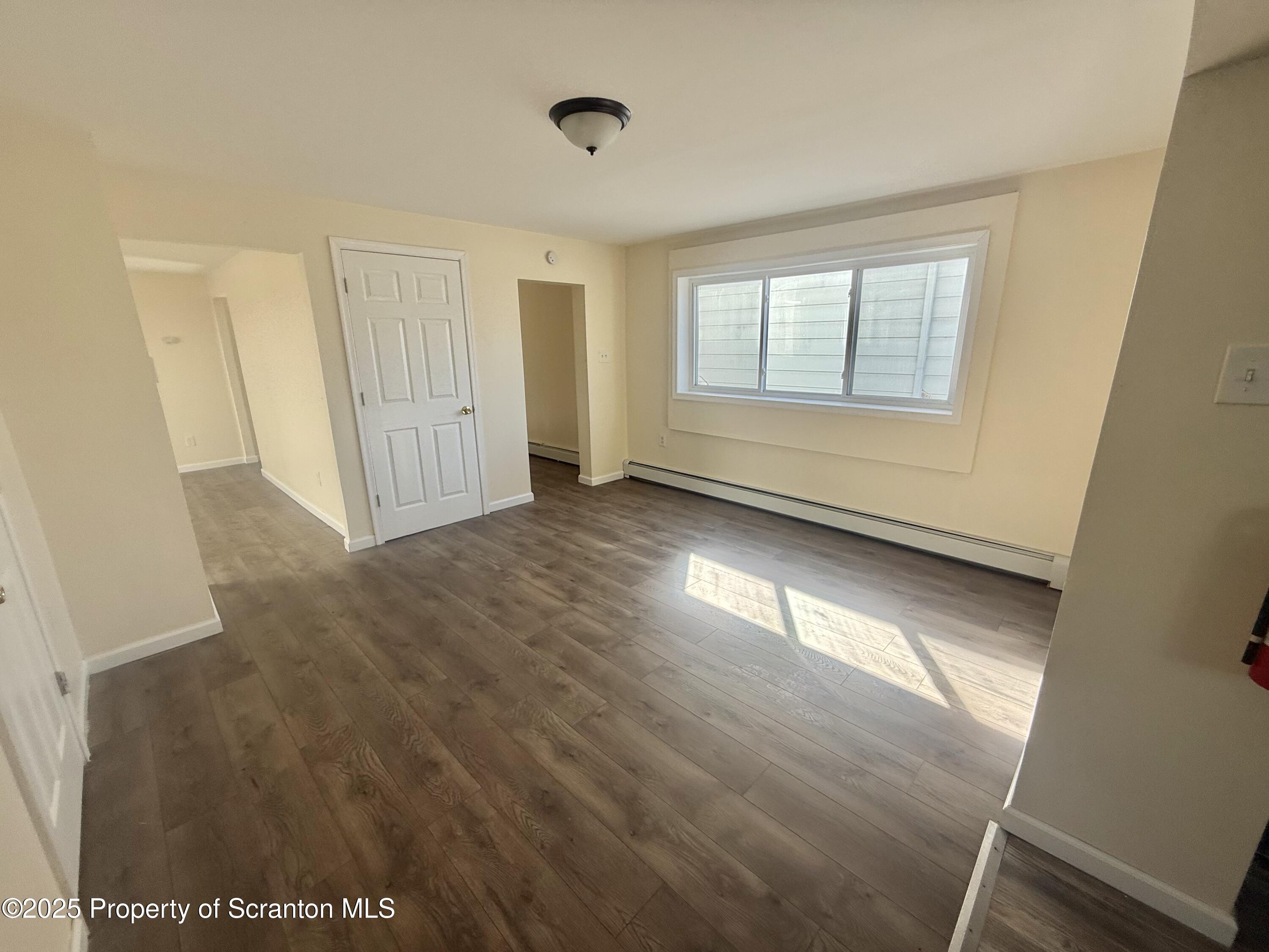 154 South Sumner Avenue Scranton, PA 18504 - Photo 4 of 15 a view of an empty room with wooden floor and a window