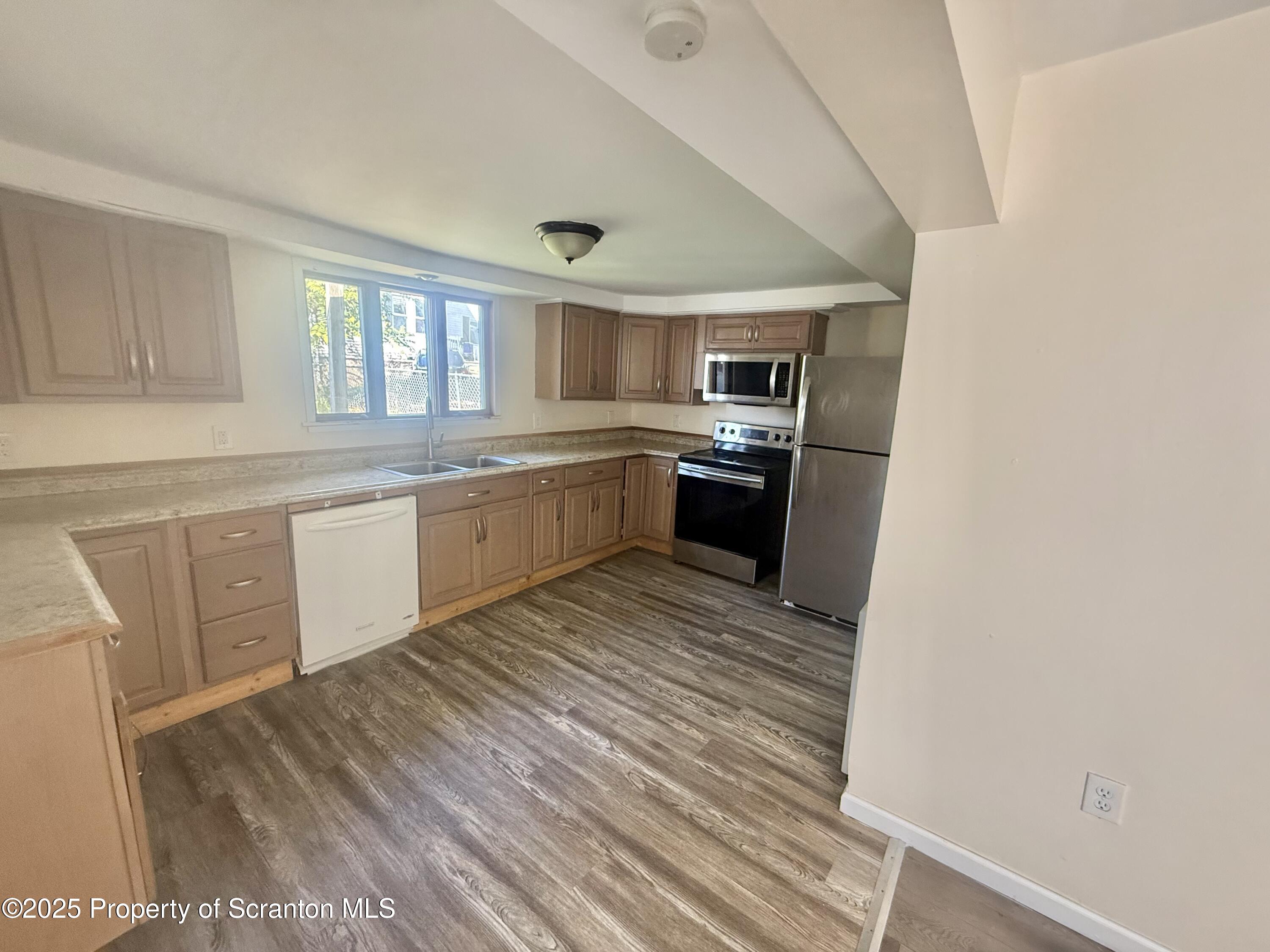 154 South Sumner Avenue Scranton, PA 18504 - Photo 5 of 15 a large kitchen with wooden floor and stainless steel appliances
