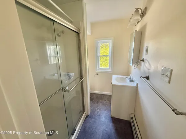 a room with a sink and wooden floor