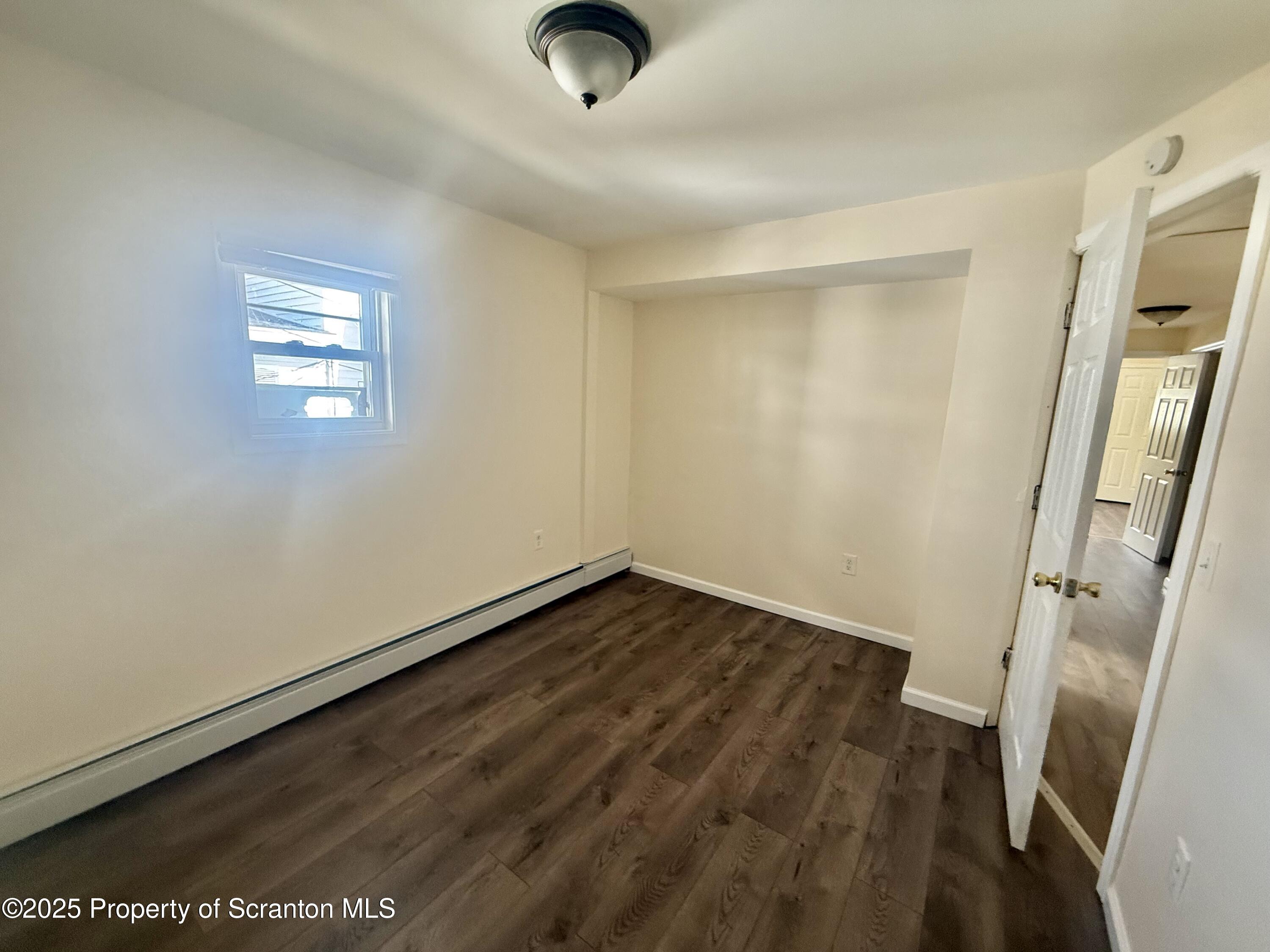 154 South Sumner Avenue Scranton, PA 18504 - Photo 9 of 15 an empty room with wooden floor and window