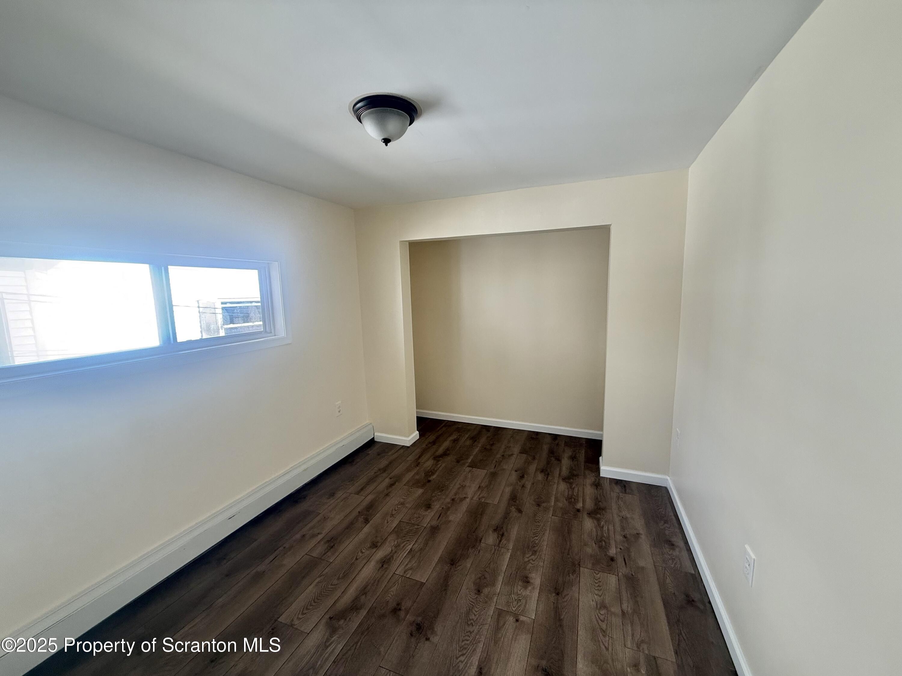 154 South Sumner Avenue Scranton, PA 18504 - Photo 10 of 15 an empty room with wooden floor and windows
