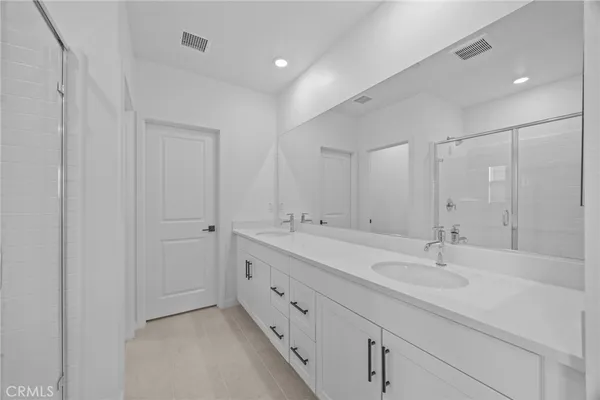 a bathroom with double sink and mirror