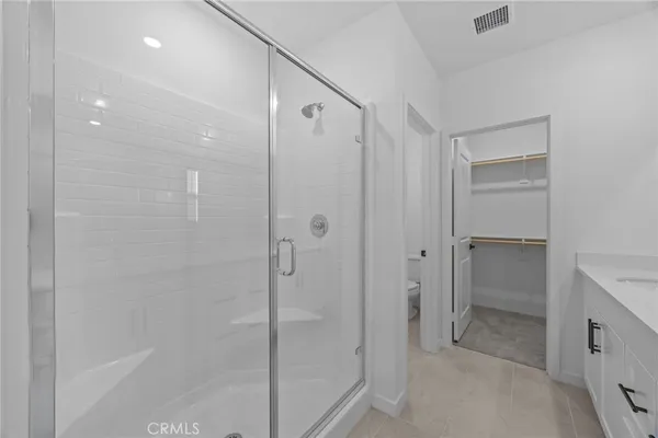a bathroom with a shower and a glass door