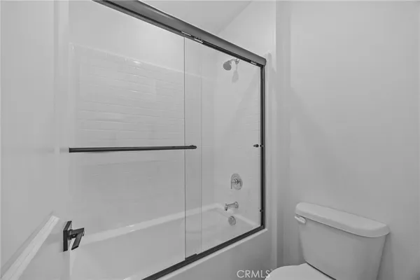 a bathroom with a shower and a toilet