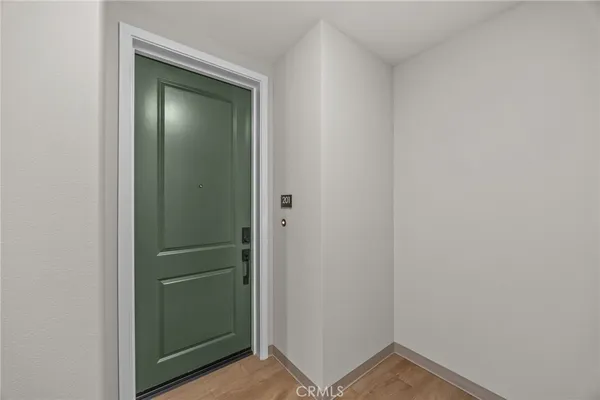 a view of a hallway with wooden floor