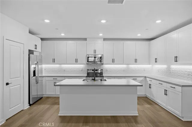 a kitchen with sink stove and cabinets