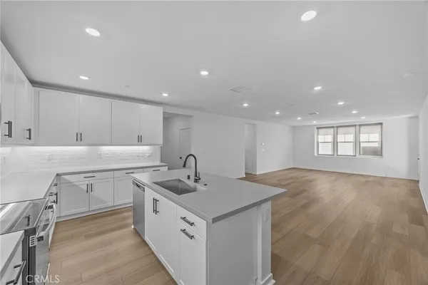 a kitchen with a sink stove and cabinets