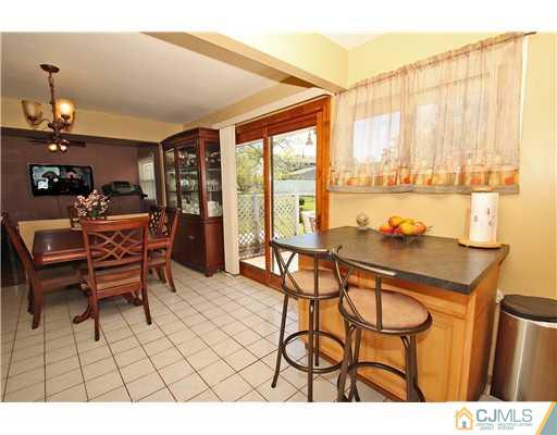 19 New Road Kendall Park, NJ 08824 - Photo 12 of 21 a dining room with furniture and a floor to ceiling window