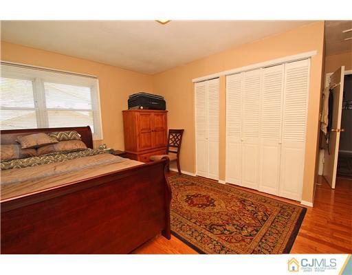 19 New Road Kendall Park, NJ 08824 - Photo 14 of 21 a bedroom with a bed and wooden floor