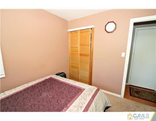 19 New Road Kendall Park, NJ 08824 - Photo 18 of 21 a view of an empty room and wooden floor